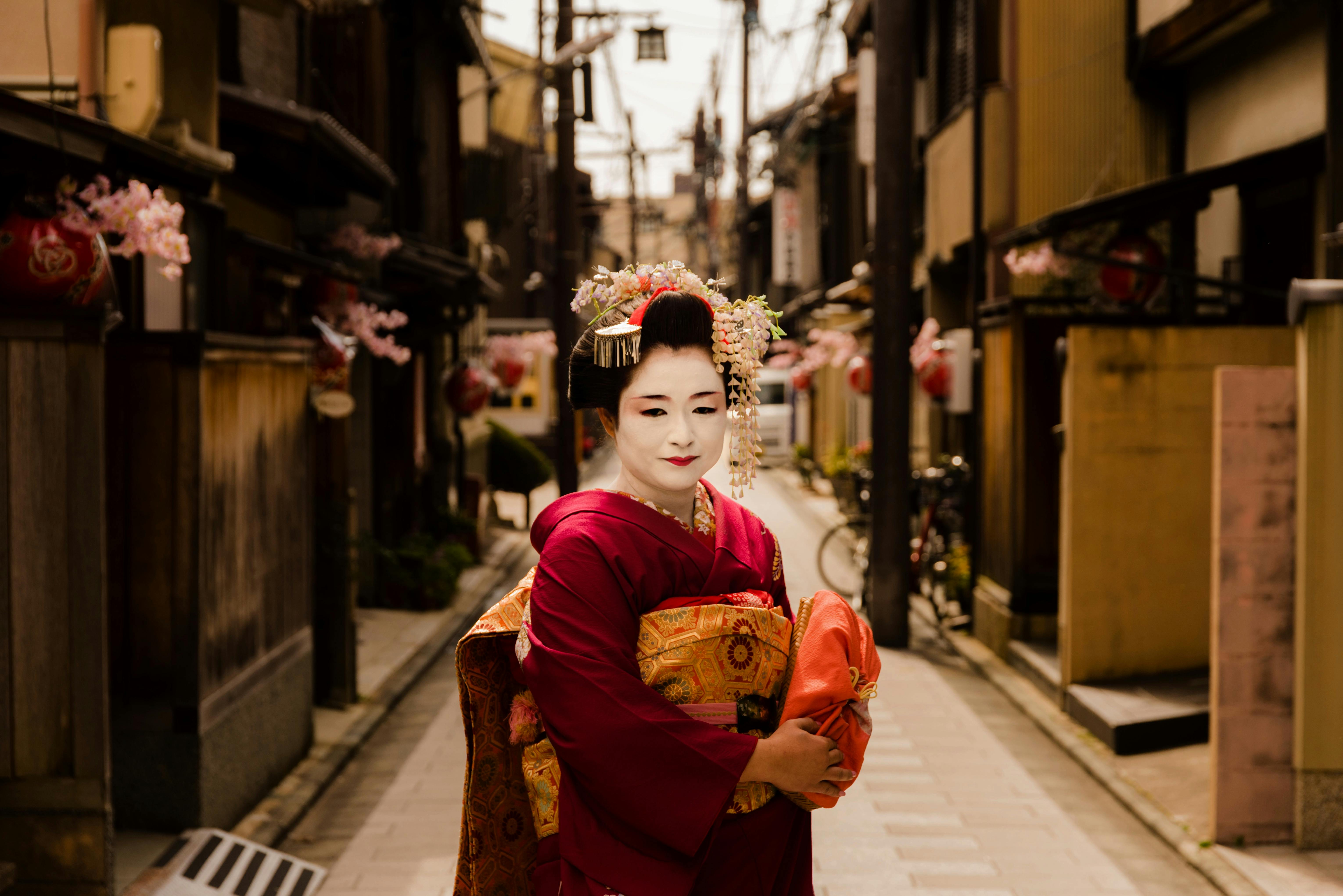 Geisha in vibrant kimono seen on a traditional street in Kyoto, Japan.