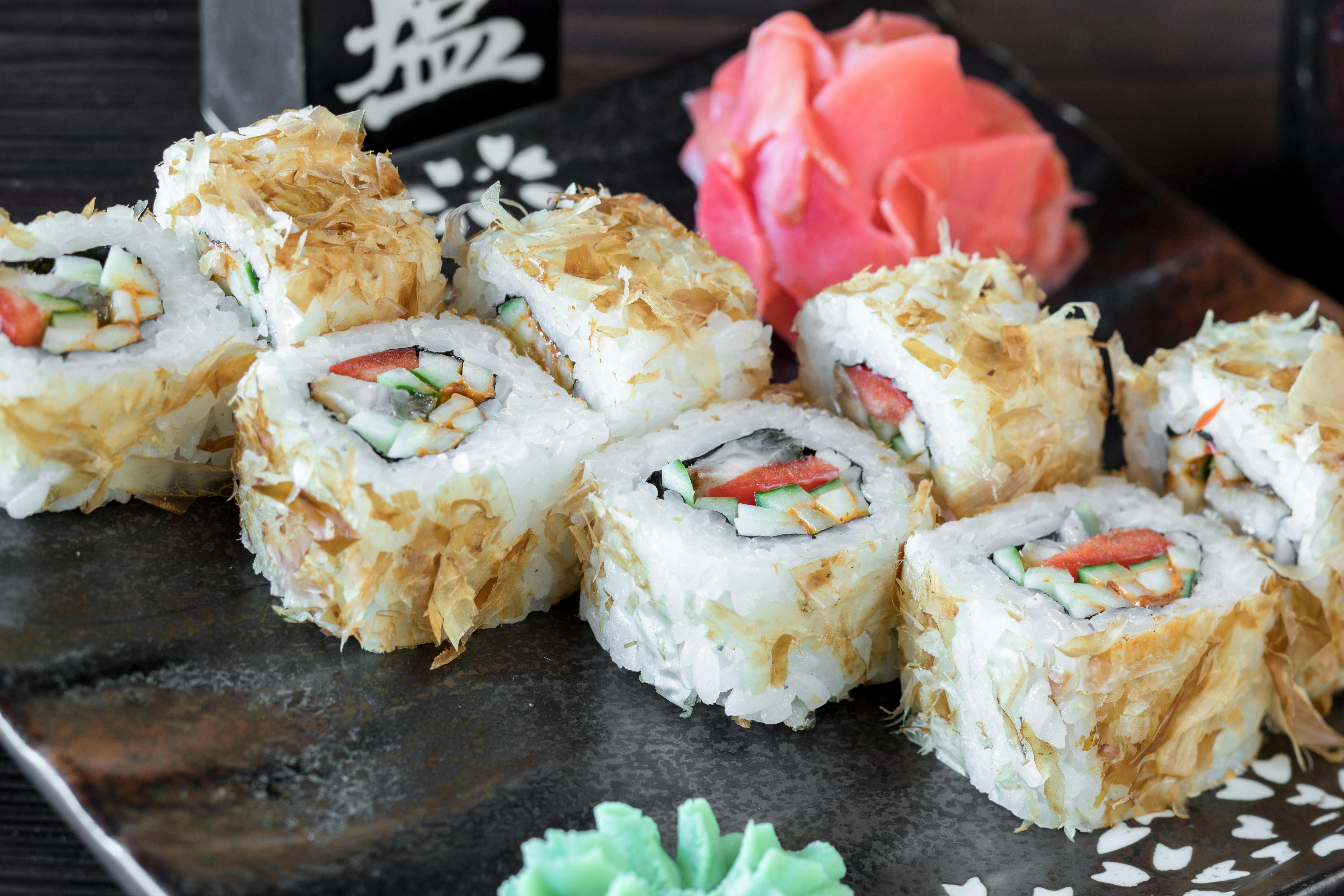 Close-up of a sushi platter with ginger and wasabi, featuring decorative Japanese elements.