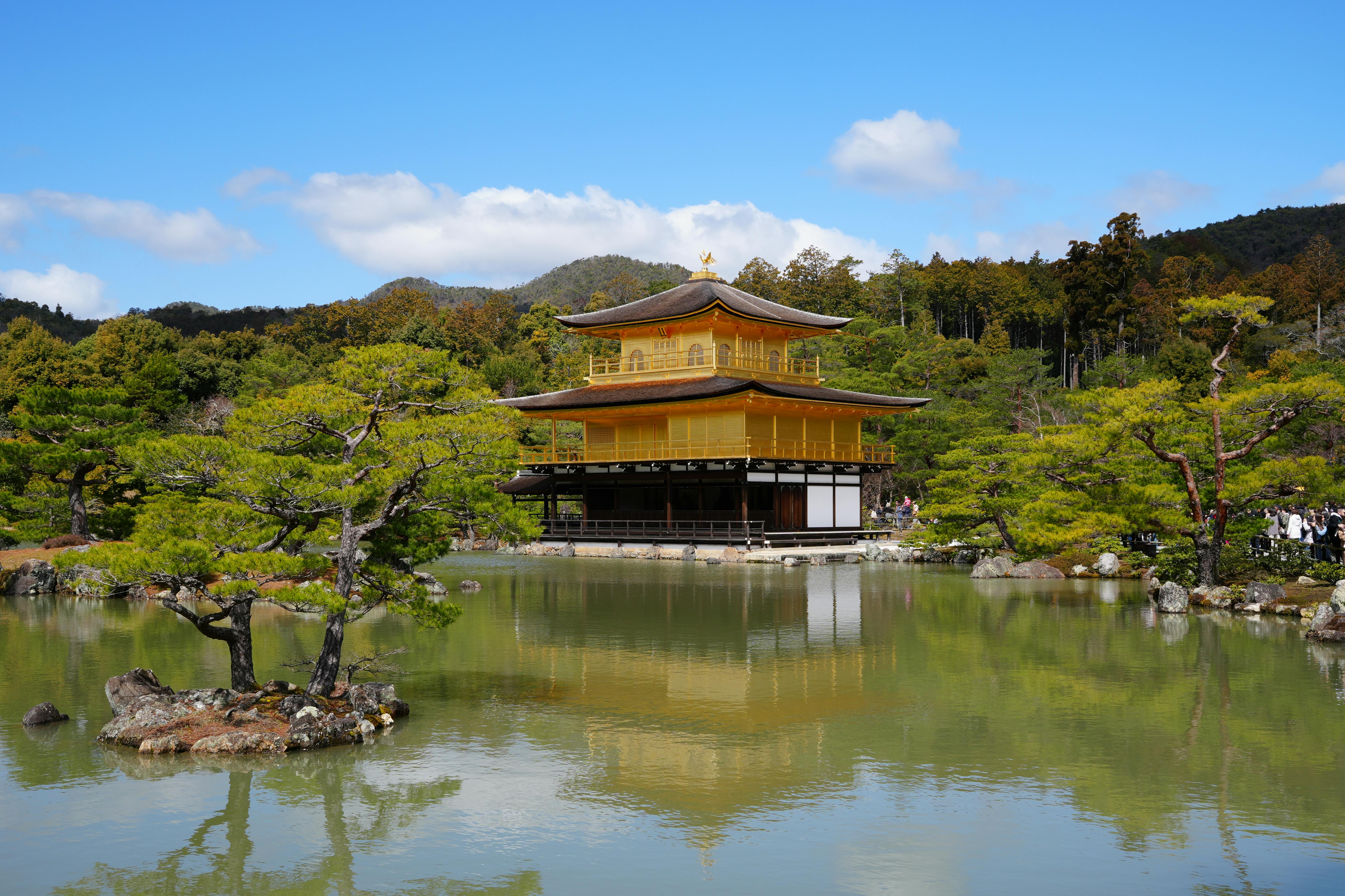 Stunning view of Kinkaku-ji Temple in Kyoto, Japan, reflecting in tranquil pond surroundings.