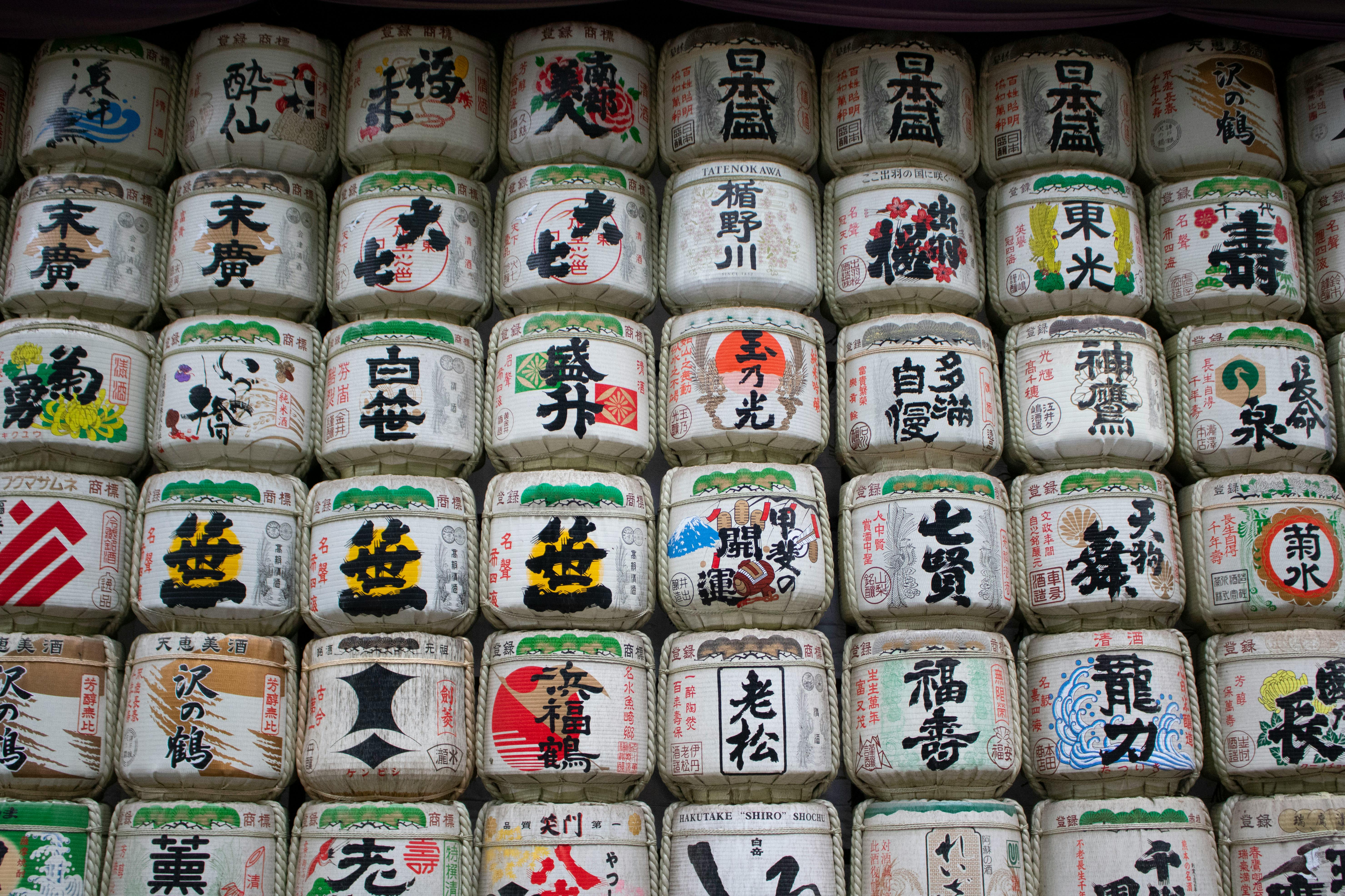 Colorful display of traditional sake barrels in Japan, showcasing cultural artistry.